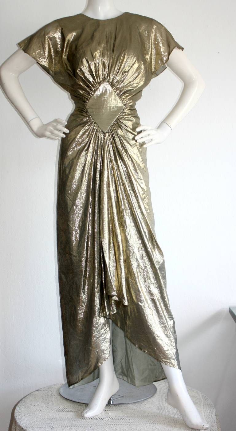 Princess Diana's FAVORITE designer, Bruce Oldfield!!! Fabulous gold lame, with so much detail. Sexy plunging back. Slimming effect. Fully lined, and in great condition. Approximate Size Small

Measurements:
36 inch bust
26 inch waist
44 inch
