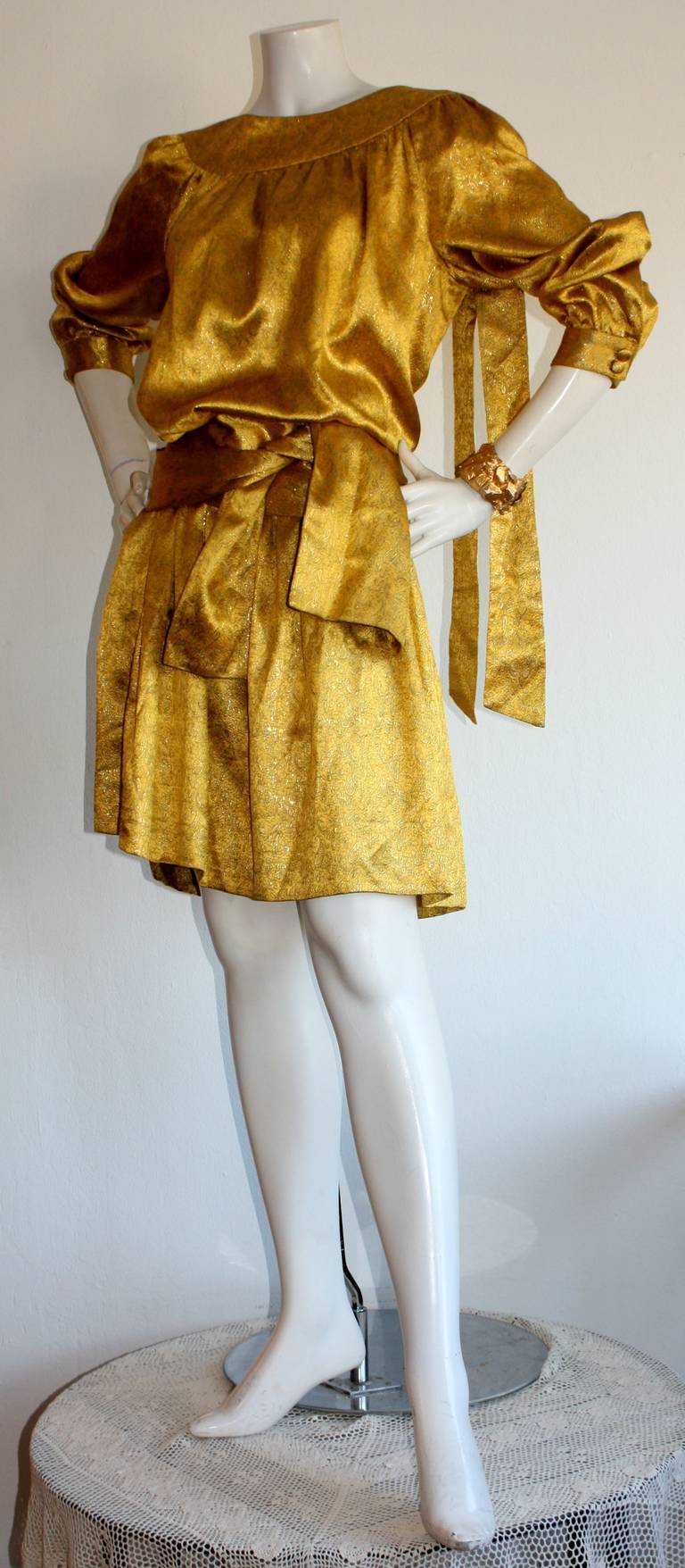 Stunning vintage Brioni dress and sash (can be worn as belt, or headscarf). Pretty oriental themed print woven in gold silk thread throughout. Fabulous drop waist that can be worn so many different ways! Shoulder features matching ribbon that can be