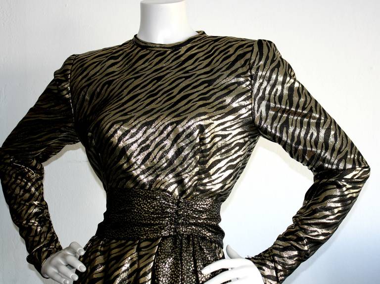 Remarkable vintage Pauline Trigere gold lame animal print dress! Features long sleeves, with zips. Attached belt buttons in front, with four closures. Fully lined. In great condition. Approximately Size Small-Medium

Measurements:
38 inch