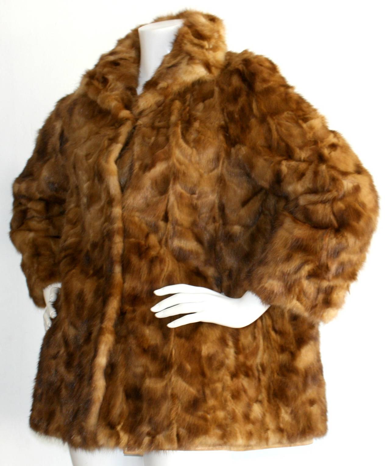 Extremely rare vintage Fendi reversible Mink Coat! Beautiful caramel honey color. Swing jacket style, that reverses to a tan suede, with pockets at waist on both mink and suede side. Can be closed on either side with three heavy duty hidden clasps