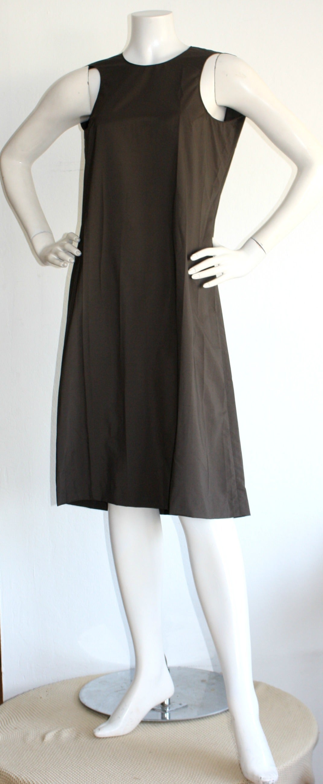 Incredible design by the great Martin Margiela! Beautiful coffee brown Avant Garde dress, with chic cascading sleeves in the front. Sleeves cover back shoulders. Coffee color has a black undertone, so this looks stunning paired with black! Signature