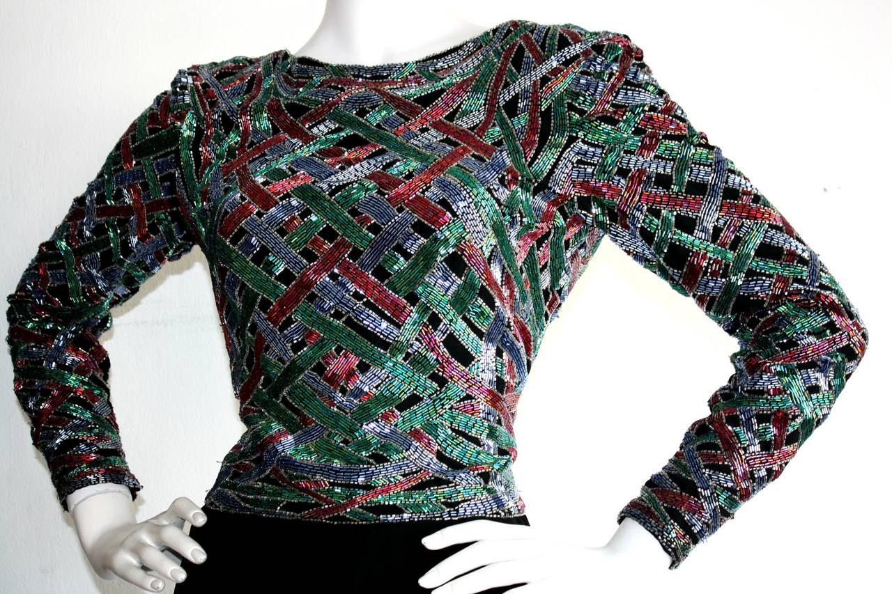 Stunning vintage Victoria Royal Ltd. heavily beaded dress!!! Red and green beading on the bodice make for a fantastic holiday dress! Beautiful draped tulip skirt that is so flattering. Elegant dipped back. Zippers on both cuffs. Fully lined. In