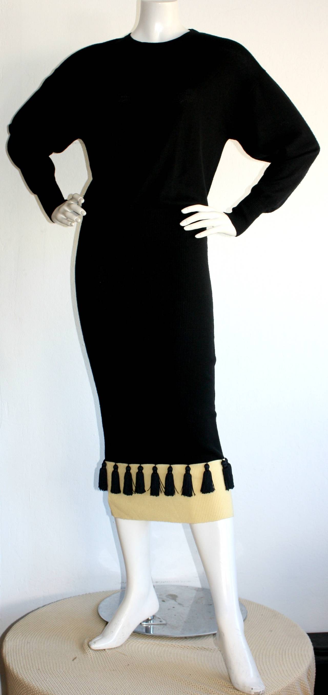 Stunning vintage Angelo Tarlazzi tassel sweater dress. Flattering fit, that can be worn as a drop-waist dress, or pulled up. Signature tassels at hem, that Tarlazzi is so well known for. Dolman sleeves that add a bit of Avant Garde to this beauty!
