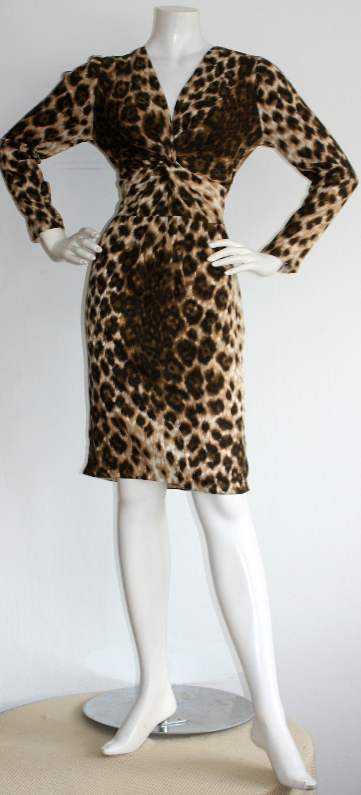 Stunning vintage Givenchy leopard/cheetah print silk dress! Features a V-bustline. Wonderful silk, with an incredible print! Zips up the back. Silk covered button at each cuff. A truly versatile piece, that fits perfectly! In great condition.