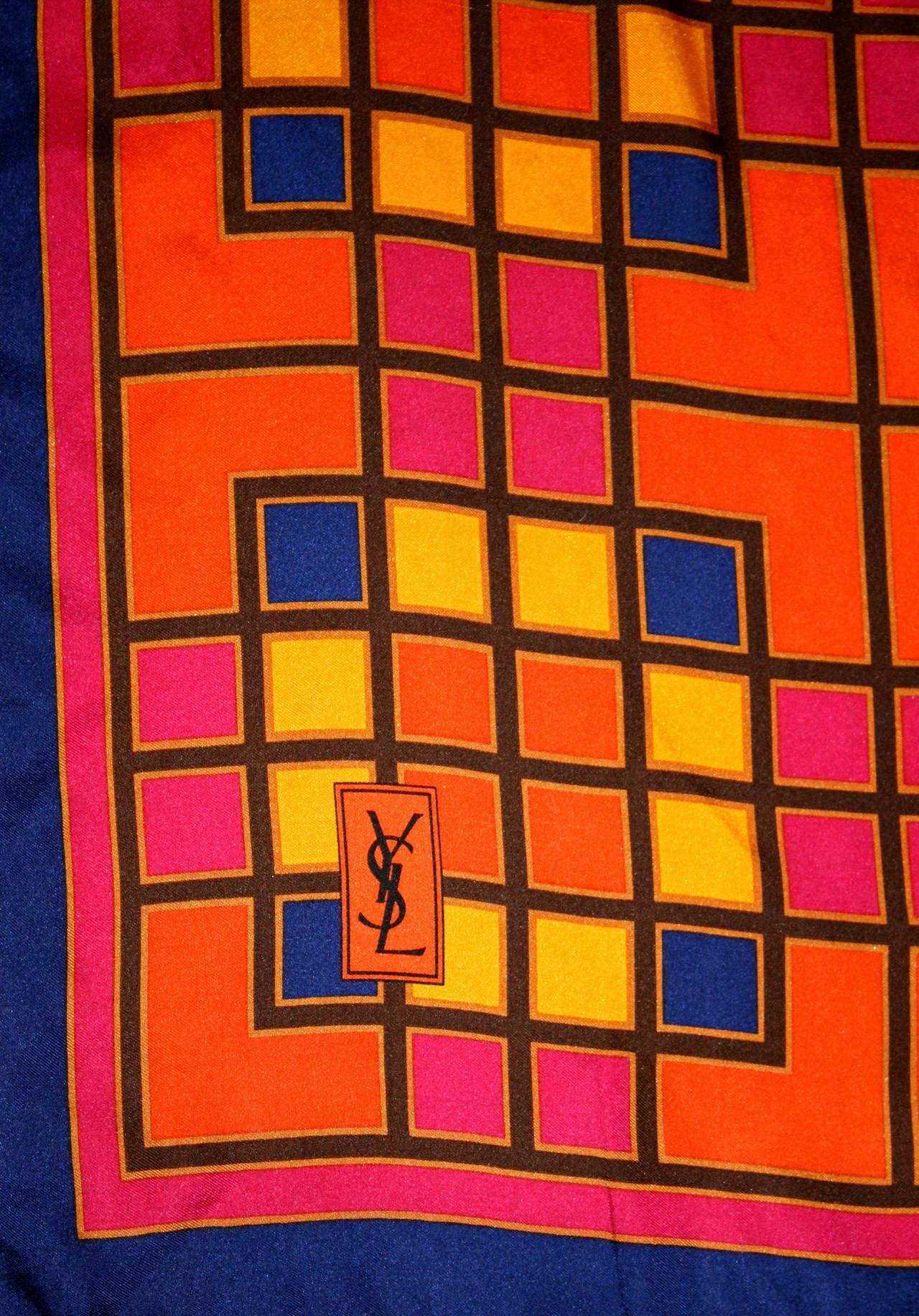 Vintage Yves Saint Laurent silk scarf, displaying signature YSL Mondrian-Inspired print! Gorgeous, vibrant hues of blues, pinks, oranges and yellows! The perfect accessory to any outfit! Can be worn a variety of ways. In great condition. 
Measures: