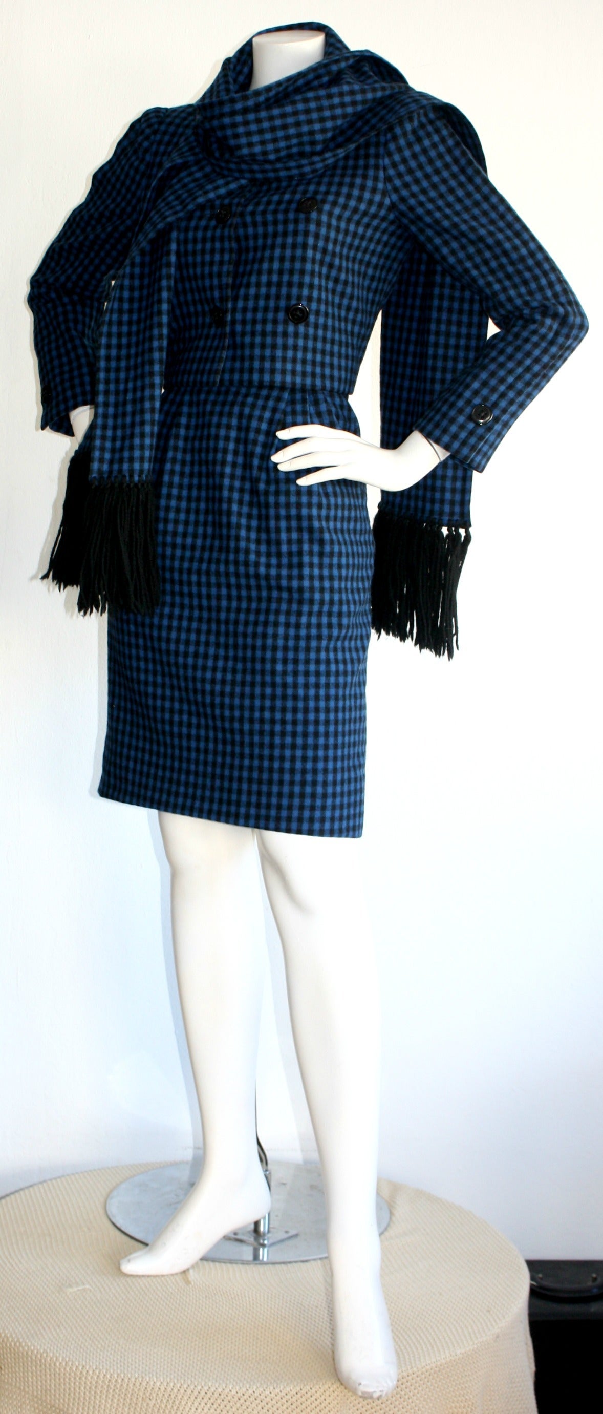Beautiful vintage 1960s Mollie Parnis 3 piece suit. Features vibrant blue & black gingham, with a cropped pill box jacket, high waisted skirt, and matching fringed scarf (that actually has buttonholes to attach to the jacket). All pieces great