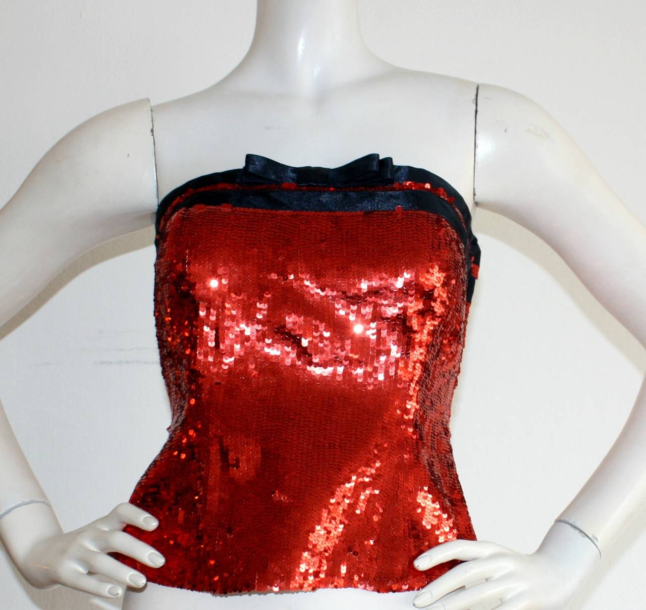 Ravishing vintage Bill BLass sequin bustier, brand new with tages still attached from Neiman Marcus! Sparkle in the all-over red sequin number, complete with a black silk bow. Fully lined. Perfect for your Holiday/New Years Party! In great