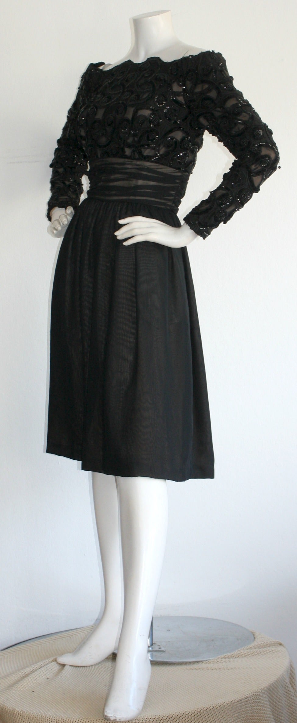 Striking vintage Kevan Hall Couture dress! Beautiful, intricate sequin detail against black chiffon. Sexy off-shoulder arms, with a nice chiffon skirt. Such a chic black dress! Fully lined. In great condition. Approximately Size