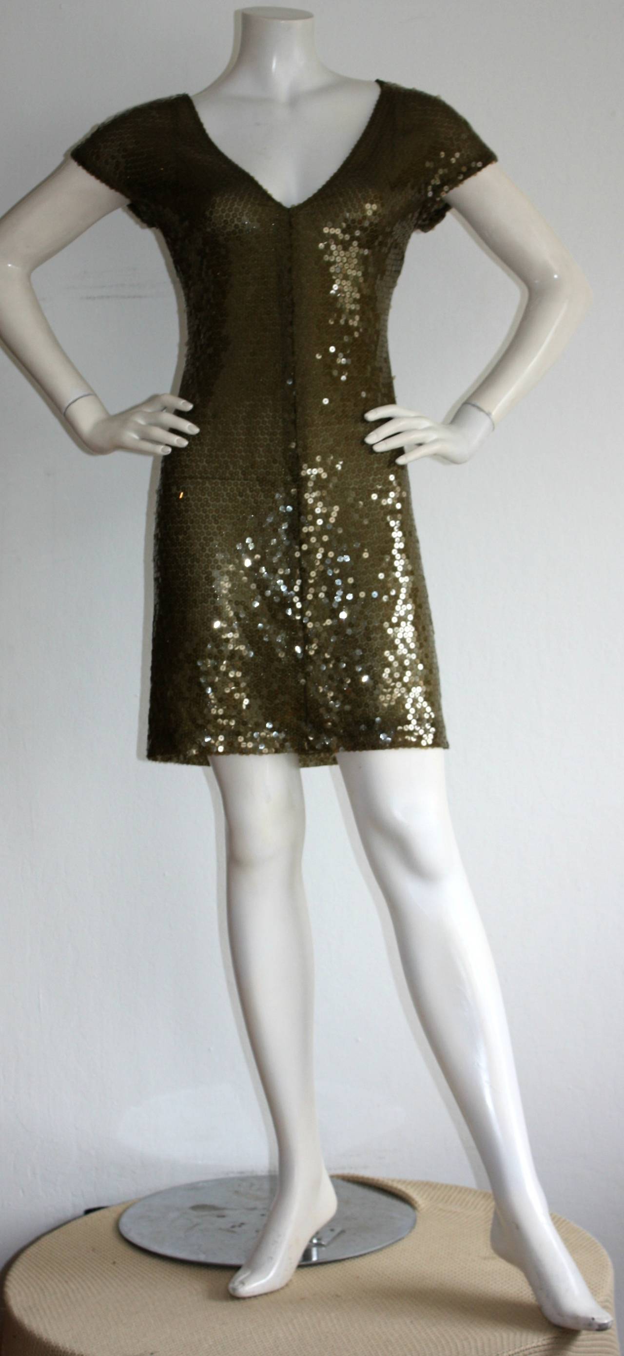 Beautiful vintage Krizia dress, with all-over hunter green sequins! Stunning color, with a flattering shape, that can be worn a variety of ways. Easily dress down, as a slouch daytime dress, with flat boots. Dress fancy, with a belt, and some