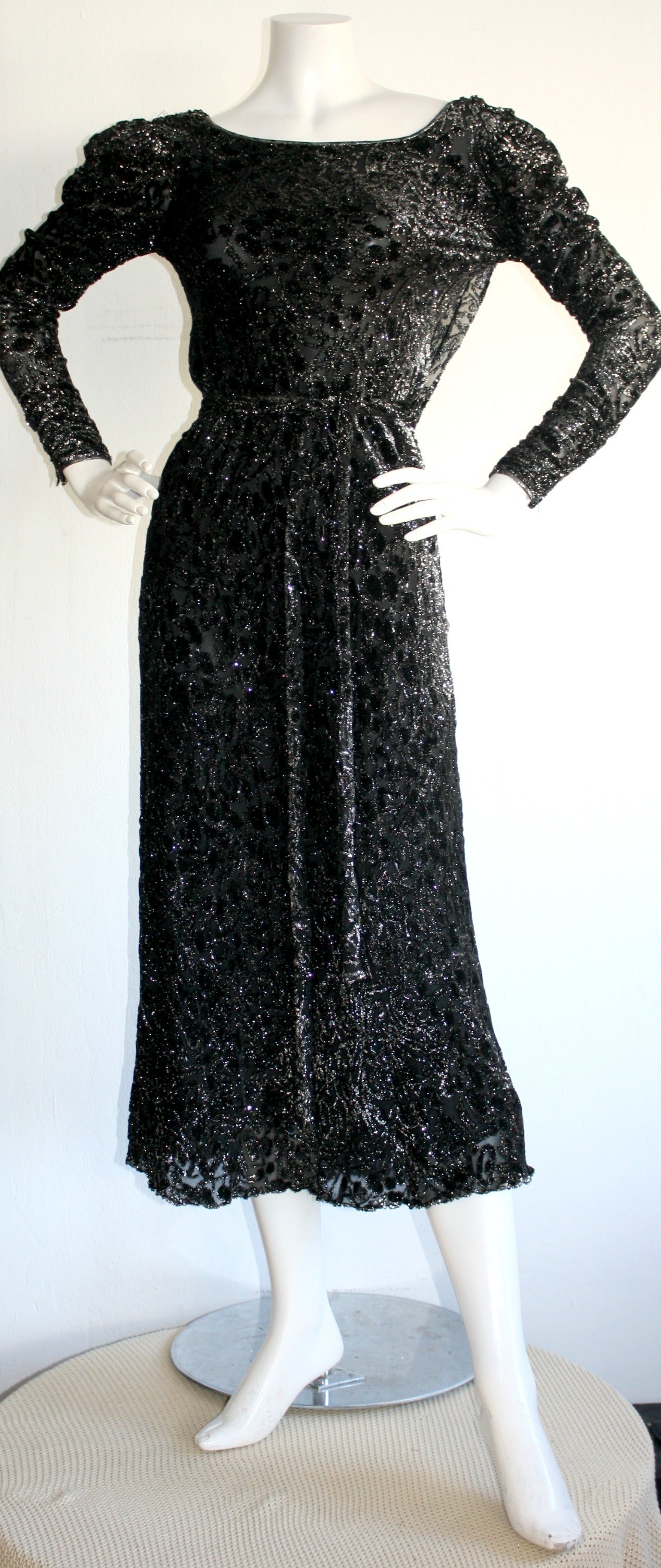Stunning vintage Mary McFadden silk black metallic gown, with tie-belt! Looks incredibly chic on, and sparkles up the room! Long sleeves, trimmed in silk. Flattering semi-plunge back, with elegant drapery. Can be worn with, or without the matching