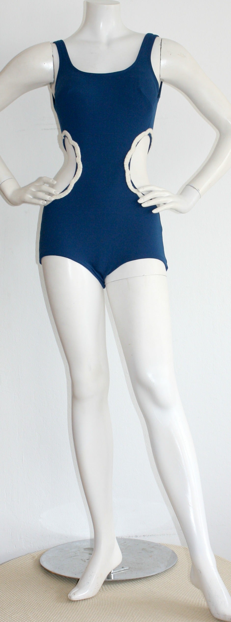 Incredibly chic vintage Oleg Cassini one-piece cut-out 1960s swimsuit. Features cut-outs at either side of the waist, to exude a fit silhouette. Beautiful royal blue color. Perfect for the pool or beach. In great condition. Approximately Size