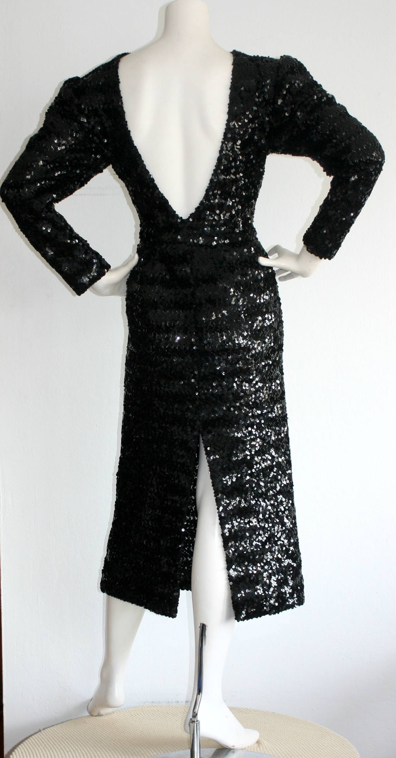Stunning vintage Paco Rabanne black sequin dress! Features all-over sequins, and a sexy. plunging back. The perfect little black dress! Hidden zipper up side. In great condition. Approximately Size Small-Medium (Has stretch)

Measurements:
36-42