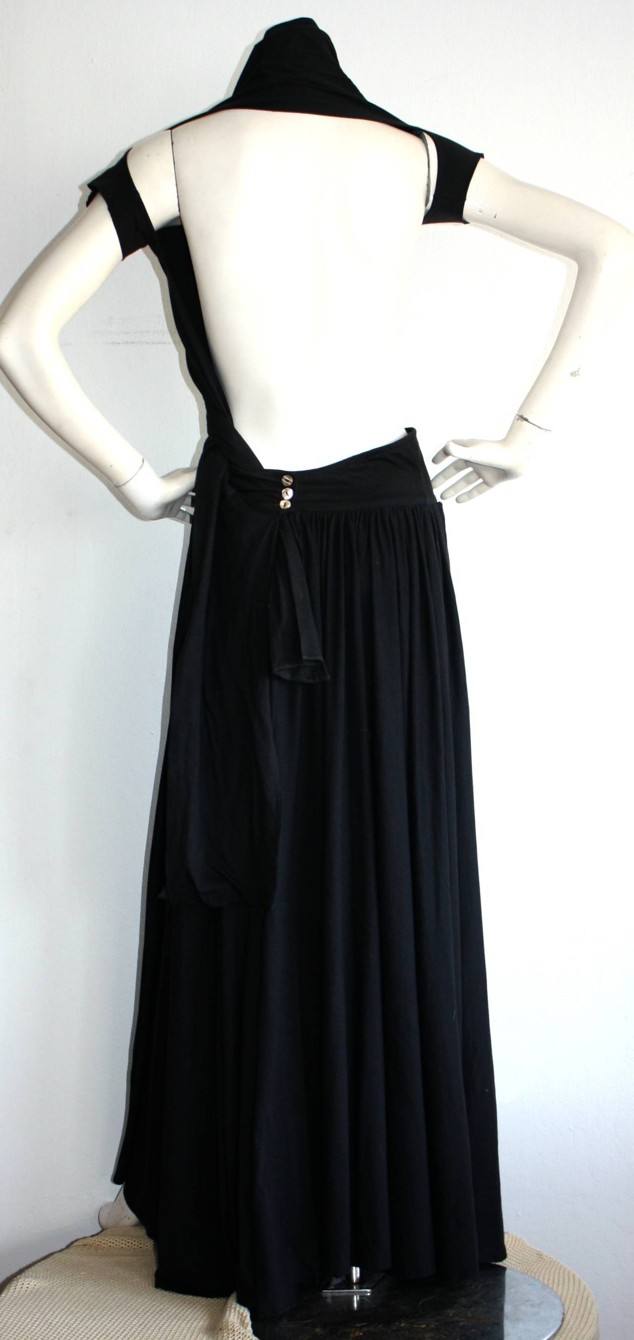 Insanely Rare vintage Romeo Gigli black dress! Wrap style, with two sleeve holes, and a sash that wraps across the chest. Sexy open back, with mother of pearl buttons at back waist. Perfect for night or day. Great with sandals, wedges, or heels. In