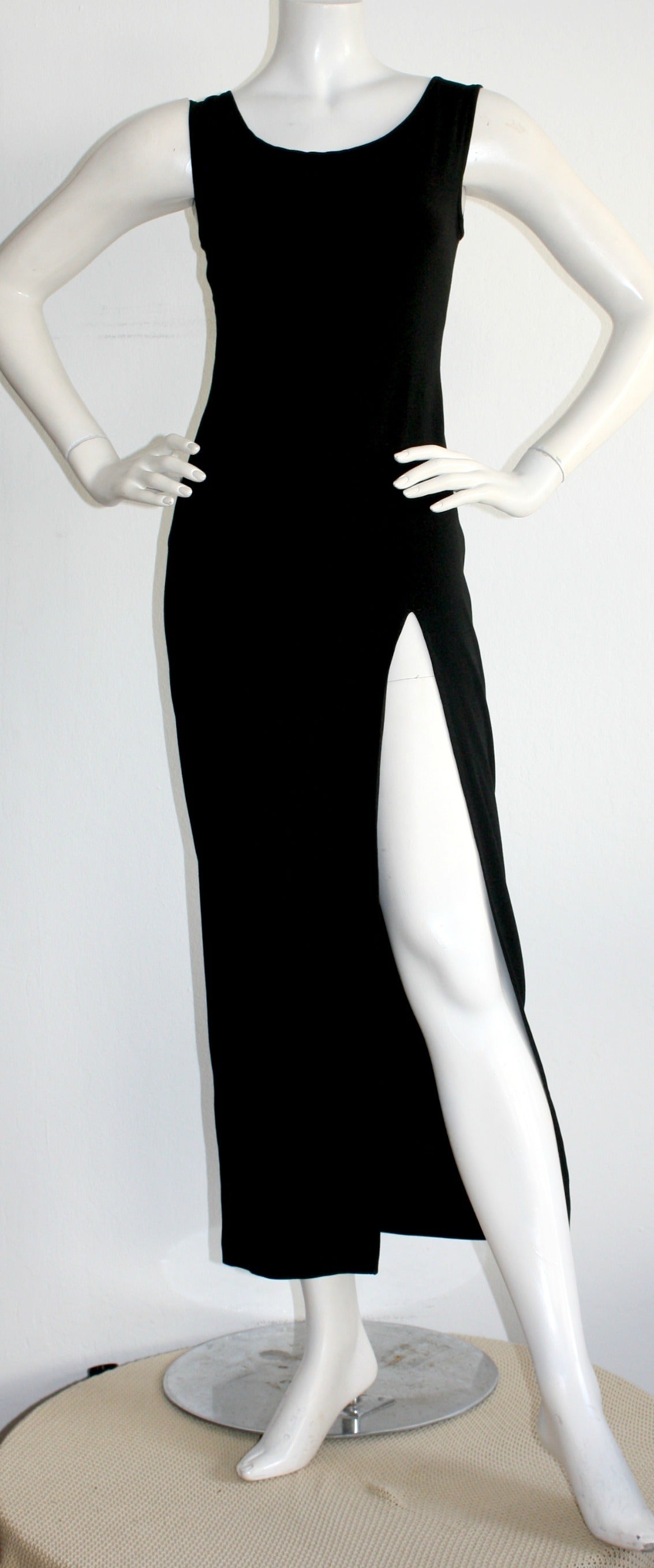 Sexy vintage Jean Paul Gaultier black dress! Who ever said black dresses have to be boring!?! This stunning number features a sexy stretch rayon blend material, that hugs the body in all the right places! Also looks great belted. Made in Italy. In