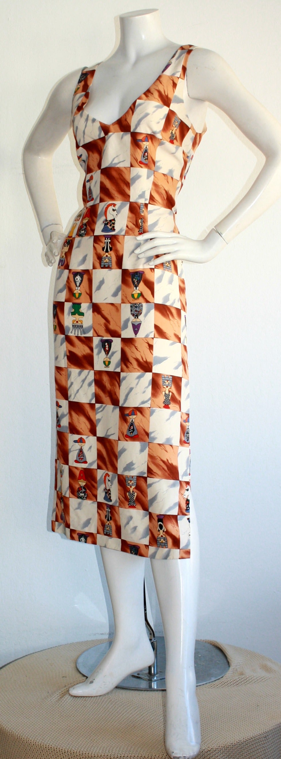 Unique, yet sexy vintage Nicole Miller dress! Flattering body-hugging (in all the right places). Beautiful dipped opening in the back. Amazing pattern of characters as Chess pieces. 100% Silk. Fully lined. Made in USA. In great condition. Marked