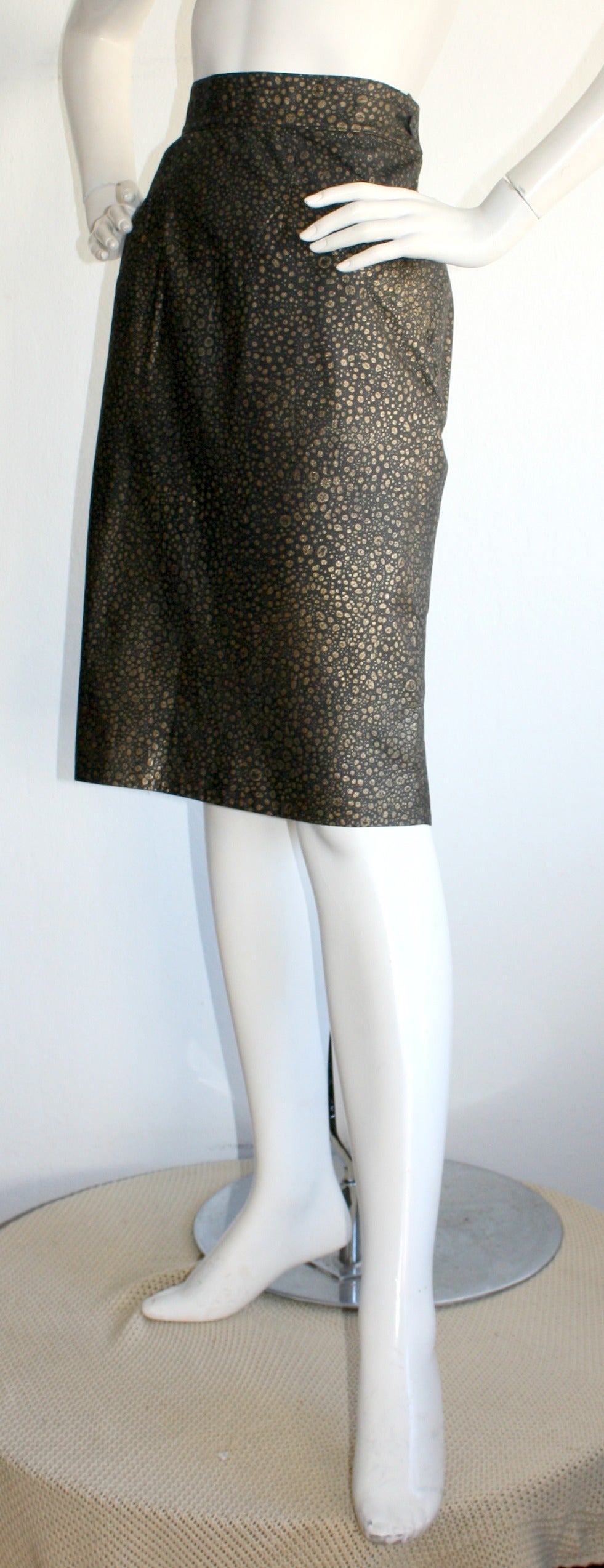 Very rare vintage Yves Saint Laurent YSL high waisted Pig Leather Skirt! Black leather, with tastefully splatters of gold metallic throughout. Stunning fit, with two pockets in front. Fully lined. In great condition. Marked Size EU