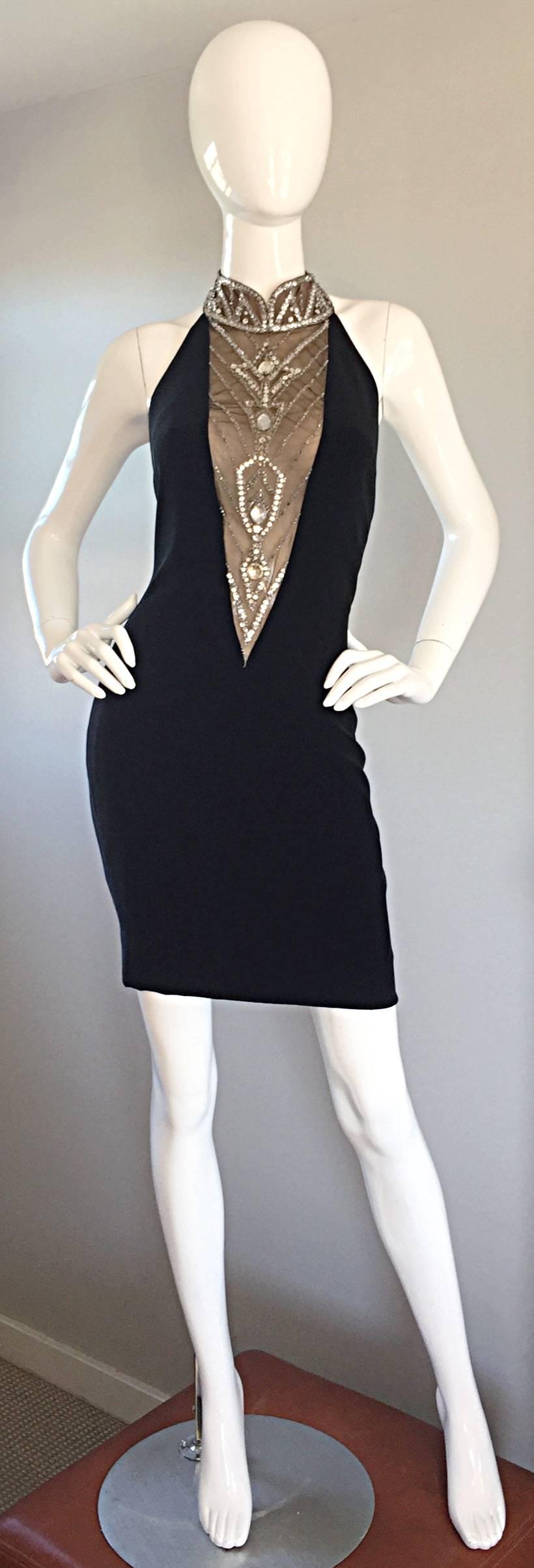 Sexiest vintage BOB MACKIE little black dress! Features a nude-illusion plunging neckline, adorned with hand-sewn sequins, crystal and rhinestones. Halter style, with beaded collar, that features hook-and-eye closures. Hidden zipper at back waist.