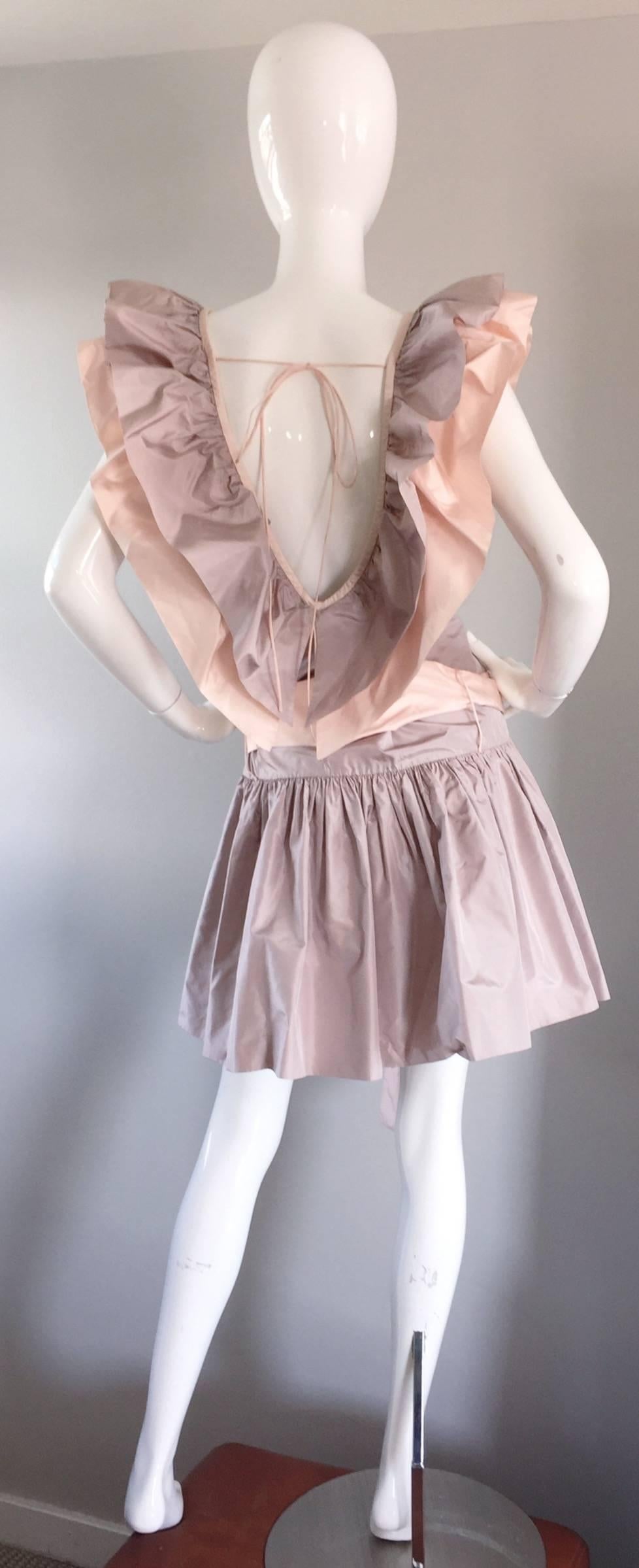 Amazing 1980s dress from hard to find designer CHRIS VAN WYK! Couture quality, with heavy attention to detail. Lavender body, with light pink sash that loops through on the drop skirt. Avant Garde pink and lavender ruffles on the front and back
