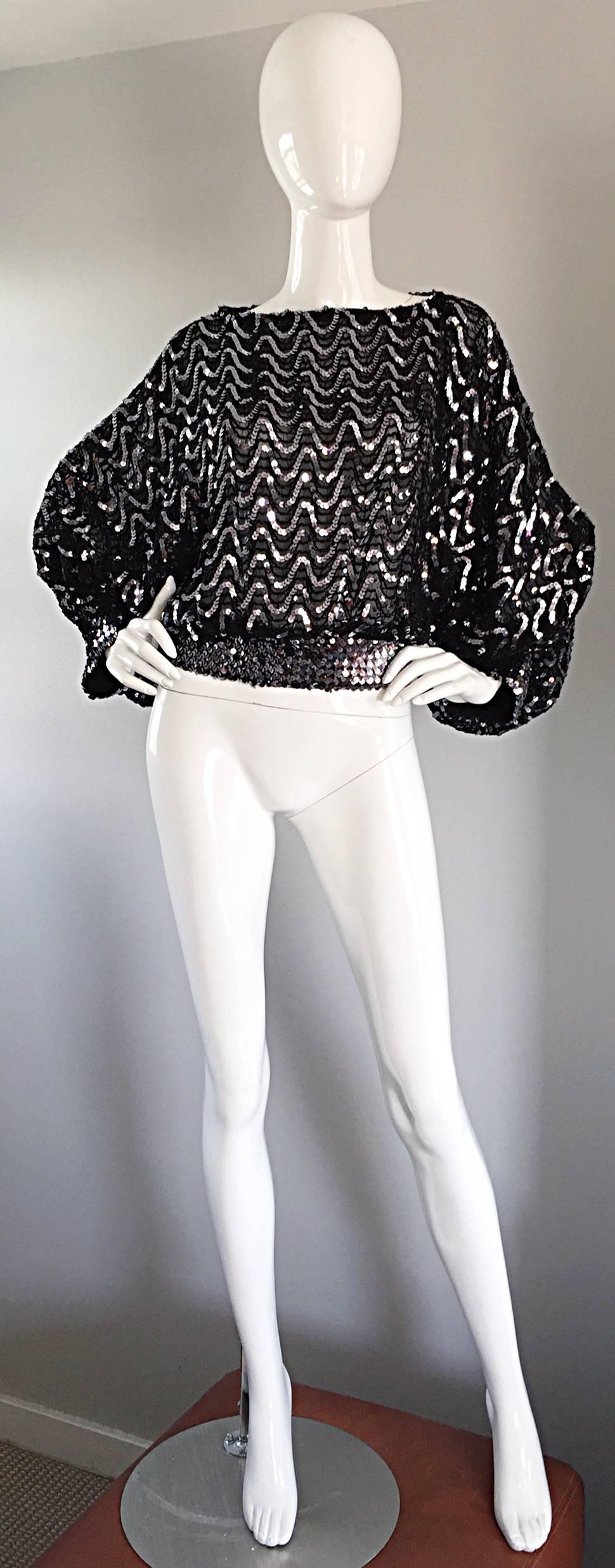 Superb vintage 1980s JEANETTE KASTENBERG for St. Martin black and silver sequin top! Features all over sequins in a zig-zag pattern. Silver sequin waistband and sleeve cuffs. Amazing full dolman sleeves. Chic peek-a-boo at back neck. Words cannot