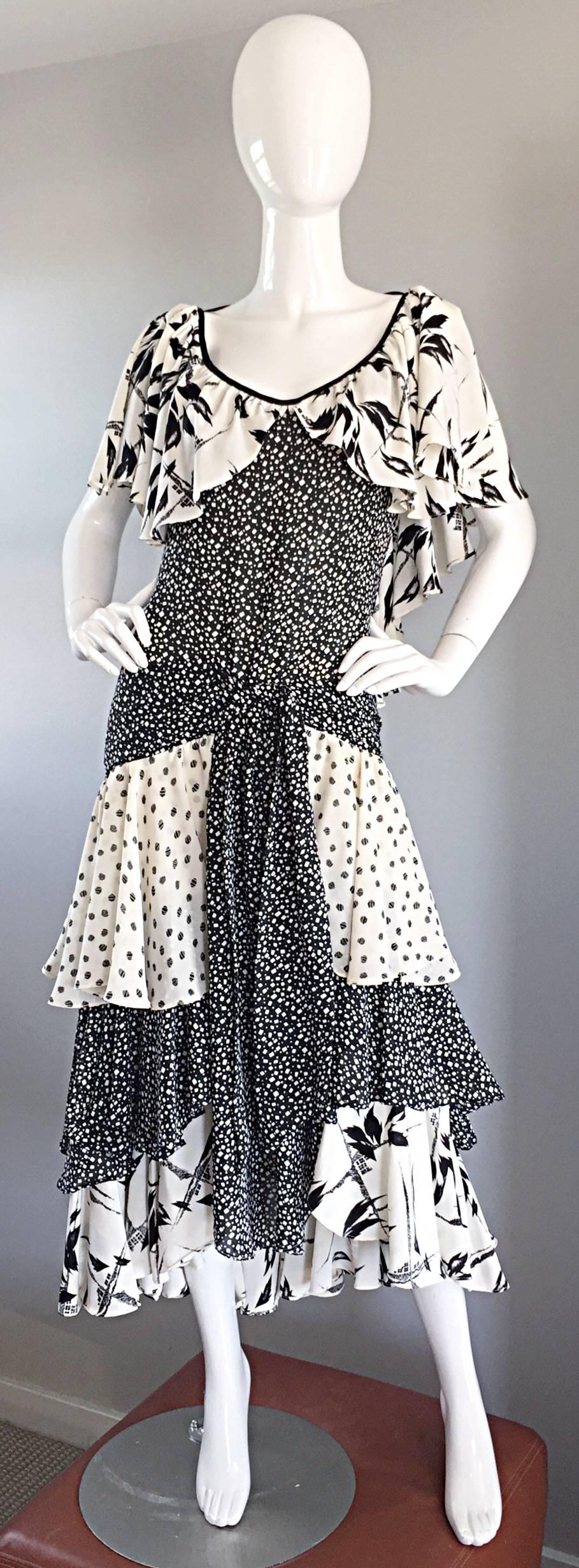 Amazing vintage LORRIE KABALA black and white multi-print dress! So much detail to this beauty, from a hard-to-find sought after vintage designer. Features a ruffled back, with a black tie in the back. Flattering drop waist, with an attached self