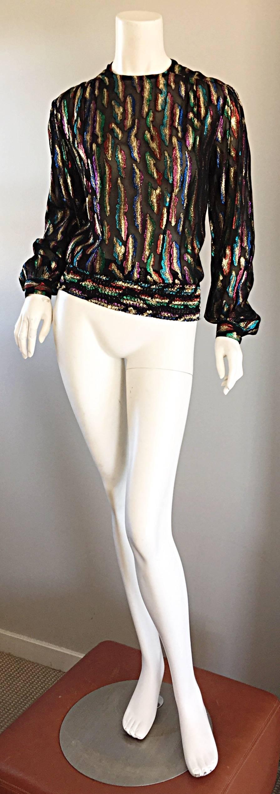 Gorgeous vintage LLYOD WILLIAMS black semi-sheer blouse, with abstract metallic threading throughout! Flattering ruched stretch waist. Button closure, with peek-a-boo back neck. Buttons at each cuff. Looks amazing on, and can easily transition from