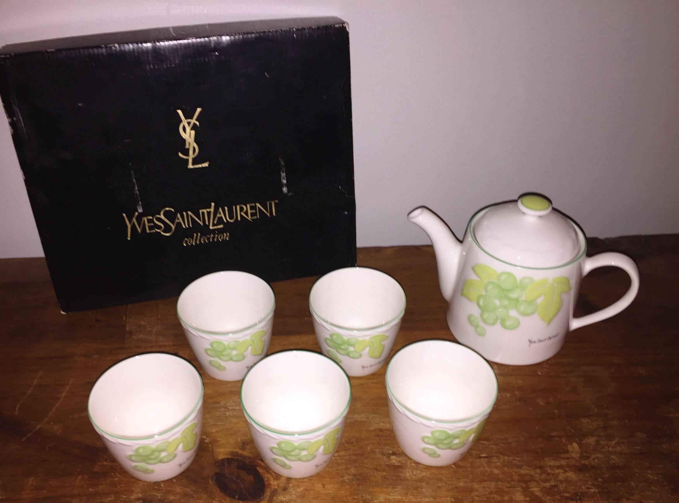 Amazing, rare vintage Yves Saint Laurent brand new tea set! Features a set of five tea cups, along with tea kettle, and infuser. Hand painted green grapes and grape leaves on each piece. Comes with original box. All pieces are signed Yves Saint