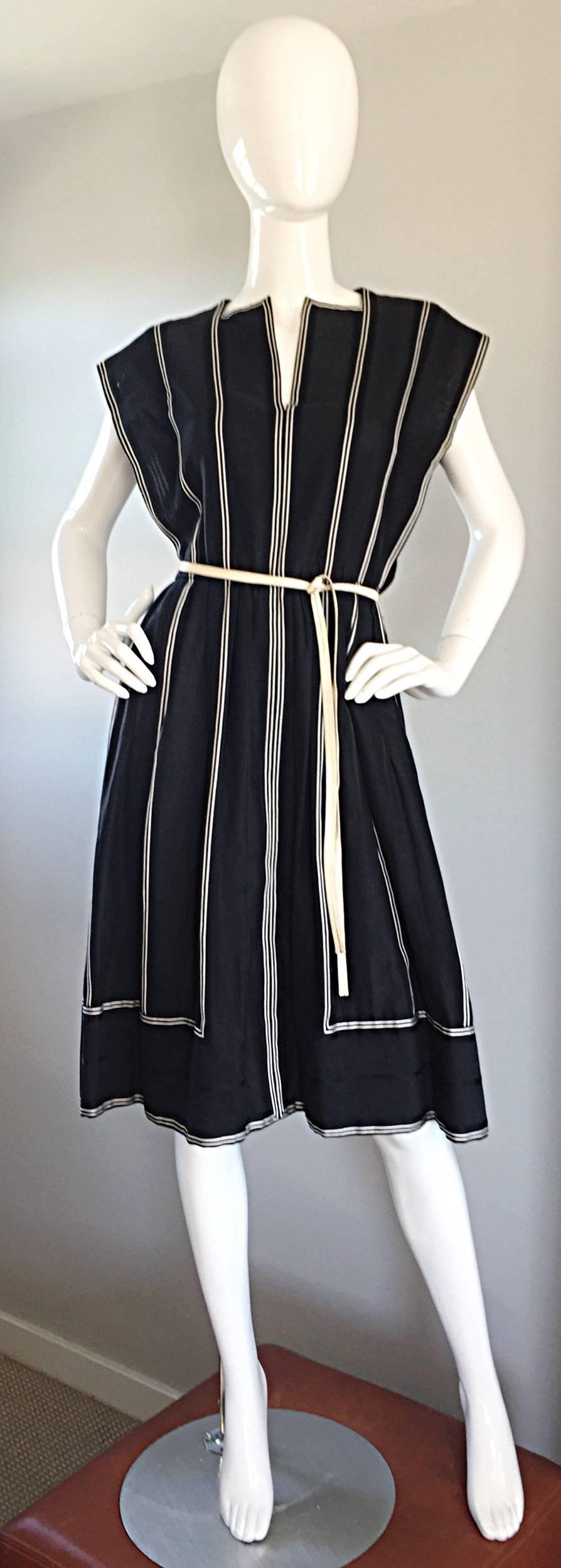 Incredible vintage PAULINE TRIGERE Avant Garde black and white dress! Black and white vertical stripes, that form rectangles at the bottom. Slashed collar, with exaggerated sleeves (no shoulder pads). Features matching detachable leather belt, that