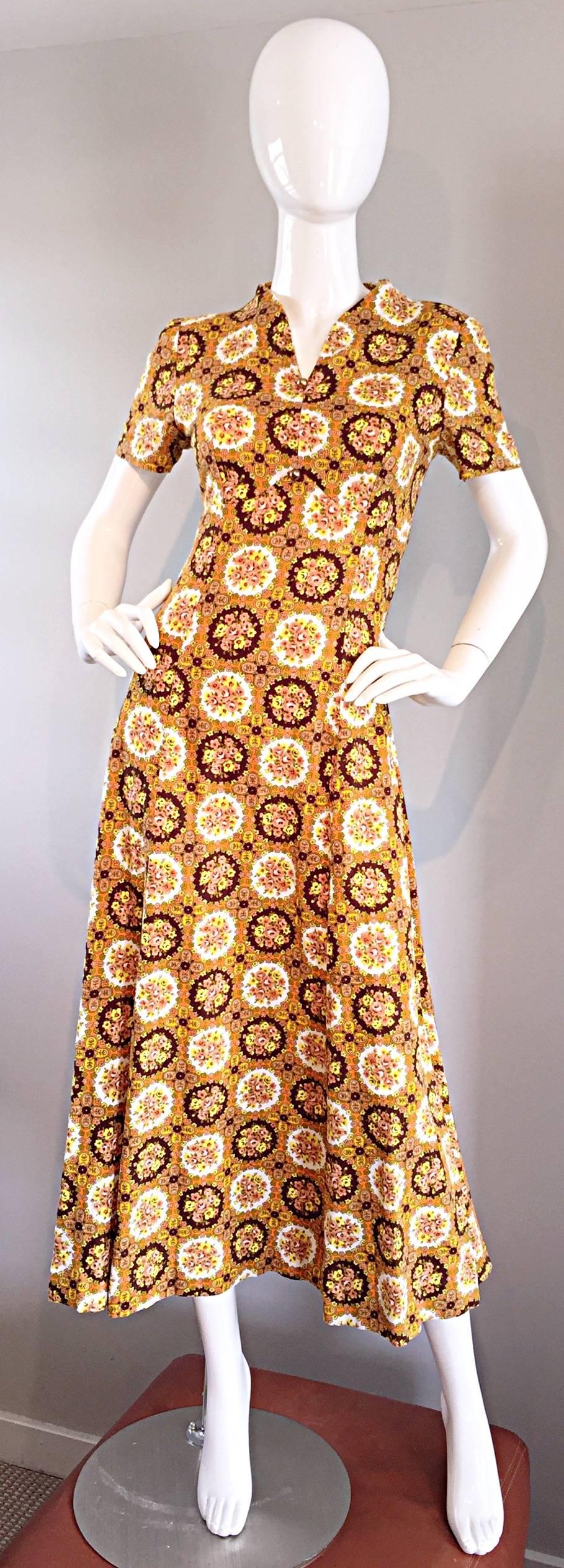 Cute 1970s JOSEPH MAGNIN cotton midi dress! Features gorgeous warm tones of orange, brown, yellow and green throughout, mixed with tiny medallion flower prints. Two gold balls at bust. Flattering v-neck, with a full skirt. Hidden zipper up the back.