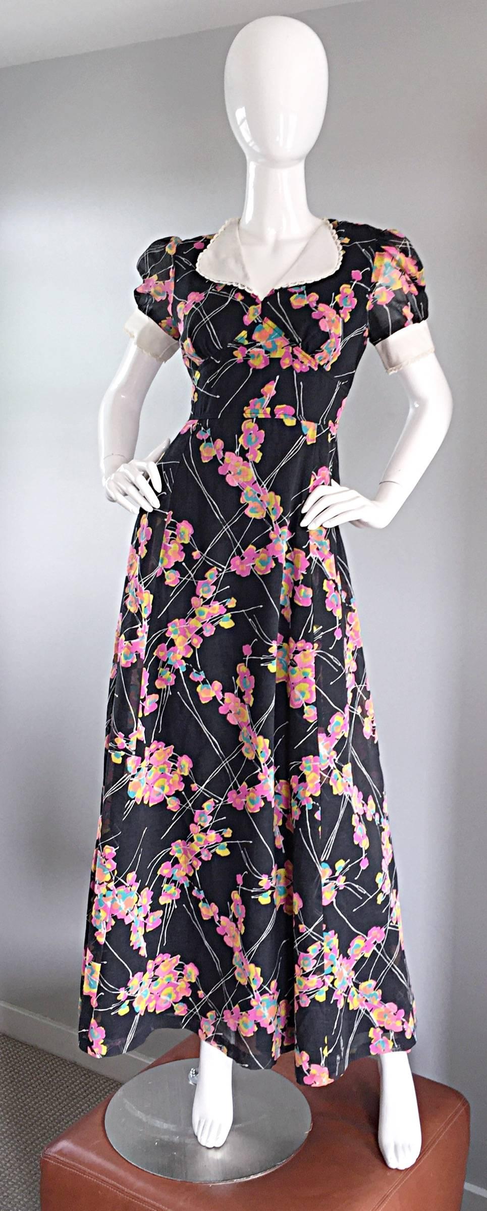 Wonderful vintage JOSEPH MAGNIN 70s does 30s black cotton short puff sleeve maxi dress! So much detail in this beauty! Features pink, blue and yellow flowers throughout, surrounded by white branches. White collar features crochet scalloped edges,