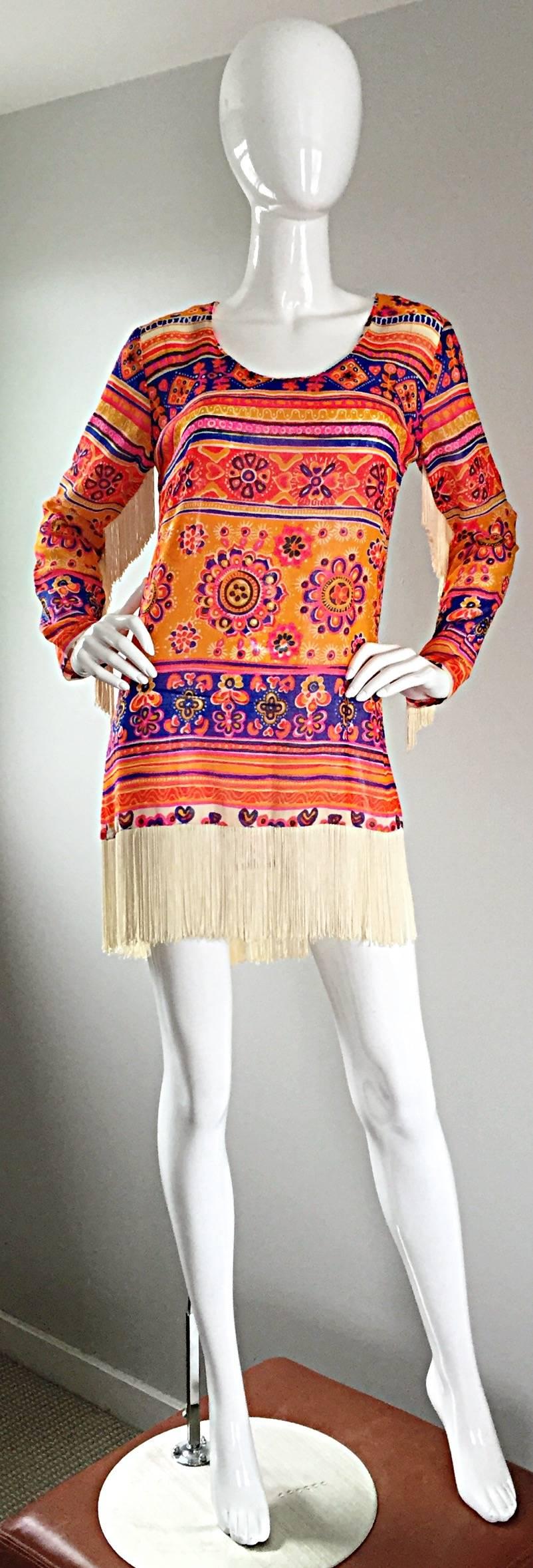 Amazing vintage 70s VICOTR BIJOU, for Joseph Magnin, colorful cotton ethnic bohhemian fringed tunic, or dress! Lightweight cotton, with vibrant ethnic print, Ivory fringe at hem, and down each back sleeve. Looks amazing on! Great belted, or alone.