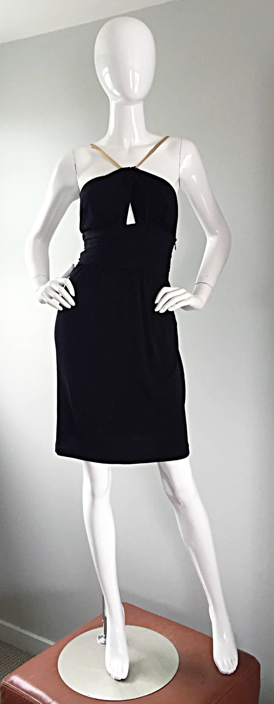 Sexy vintage CELINE dress! Black rayon jersey, that hugs the body in all the right places. Gold leather straps, and a peek-a-boo cut-out at bodice. Brilliantly strategic pleats at the waistband. Hidden zip up the side. The perfect little black