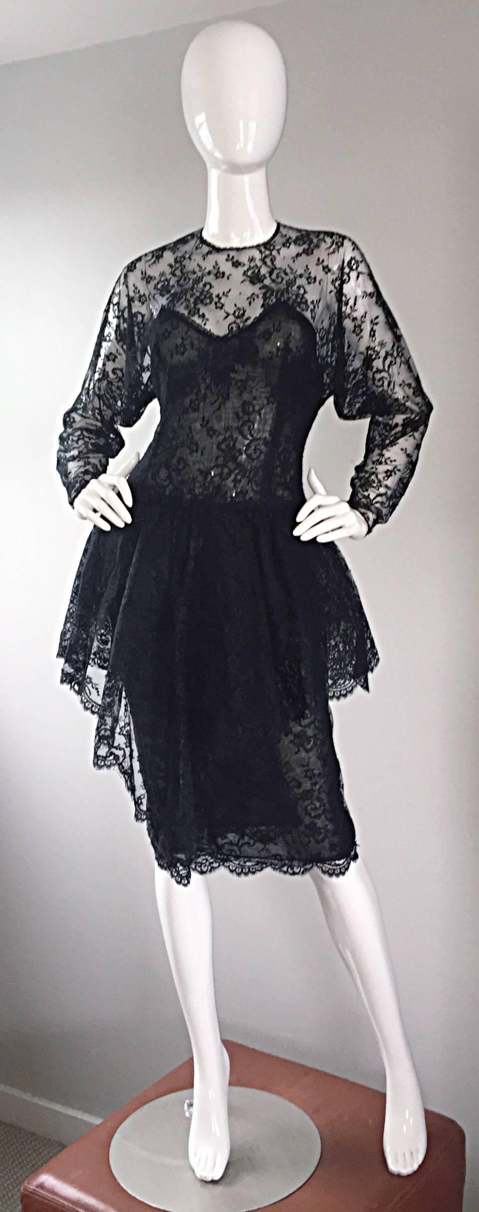 Incredible vintage late 1980s OSCAR DE LA RENTA black silk Chantilly lace dress! Couture quality, with an expert attention to detail. Chic semi sheer silk dolman sleeve lace bodice, with attached black silk double layered silk corset. Attached