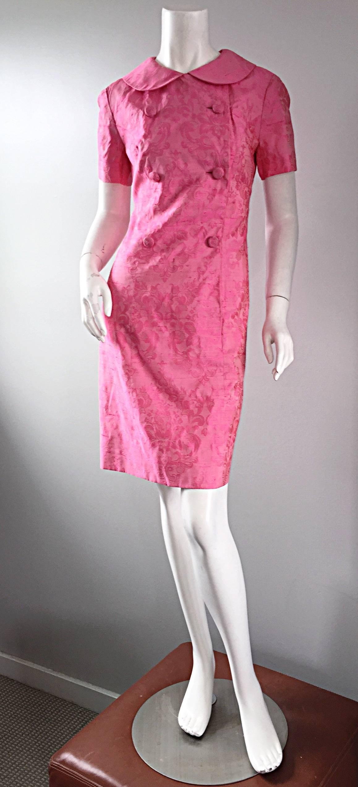 Striking vintage DYNASTY pink silk Jackie Kennedy style dress! Beautiful pink color, with Asian inspired motifs throughout. Intricate silk covered buttons up the bodice, with snaps to secure any 'gaps.' Signature 1960s 'Peter Pan' collar. Fully