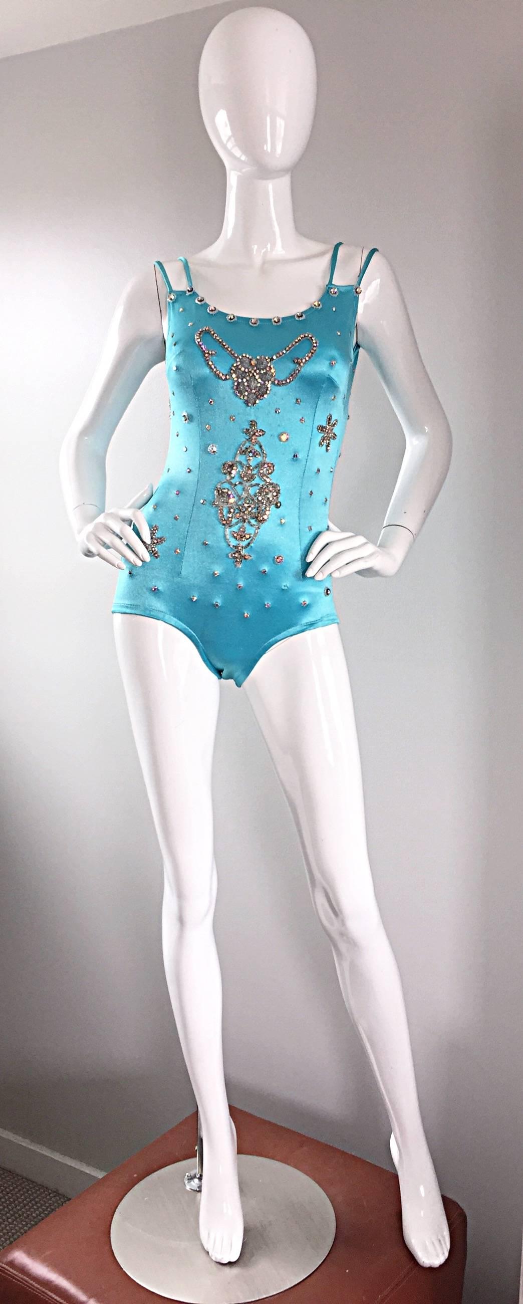 Incredible rare 1950s LAS VEGAS SHOWGIRL leotard! Beautiful aqua blue color, with rhinestones of all shapes and sizes throughout! Double strap detail that twists in the back. Perfect as a leotard, a bodysuit worn with jeans or a skirt, or as a