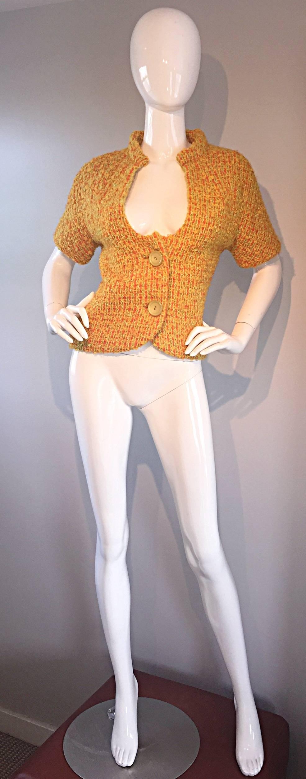 Wonderful 1960s B.H WRAGGE burnt orange boucle short sleeve jacket! Mod style, with an Avant Garde cut-out at the bodice. Two oversized buttons down the front. Fully lined. Looks great with jeans, trousers, or a skirt. In great condition.