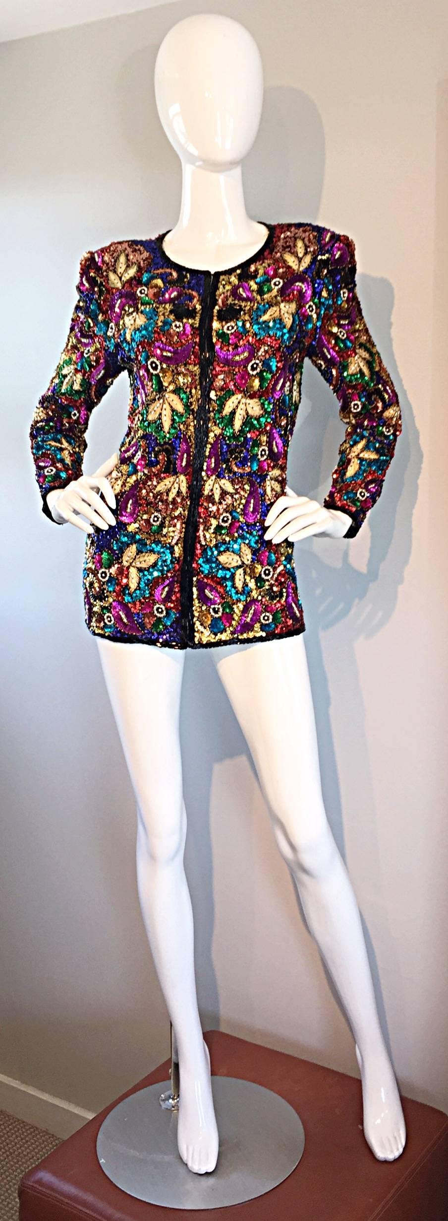 Sensational vintage silk jacket! Features thousands of hand-sewn sequins and beads throughout. Vibrant pops of color. Wonderful tailored fit, with hook-and-eye closures up the bodice. Features shoulder pads, which can easily be snipped out, if
