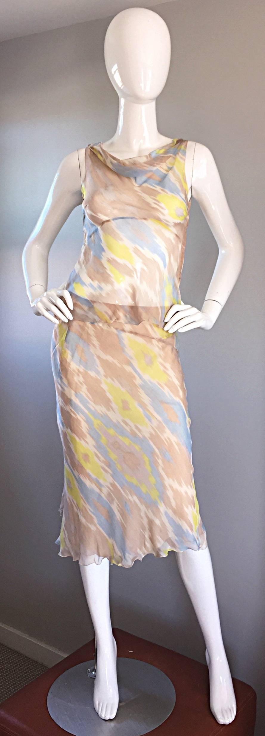 Striking 1990s ALBERTA FERRETTI dress set! Beautiful Ikat print in blue, yellow, ivory and nude, on the finest silk chiffon. Semi sheer Grecian style blouse that plunges in the back. Layers of silk under the flowy skirt. Snaps closure at side of
