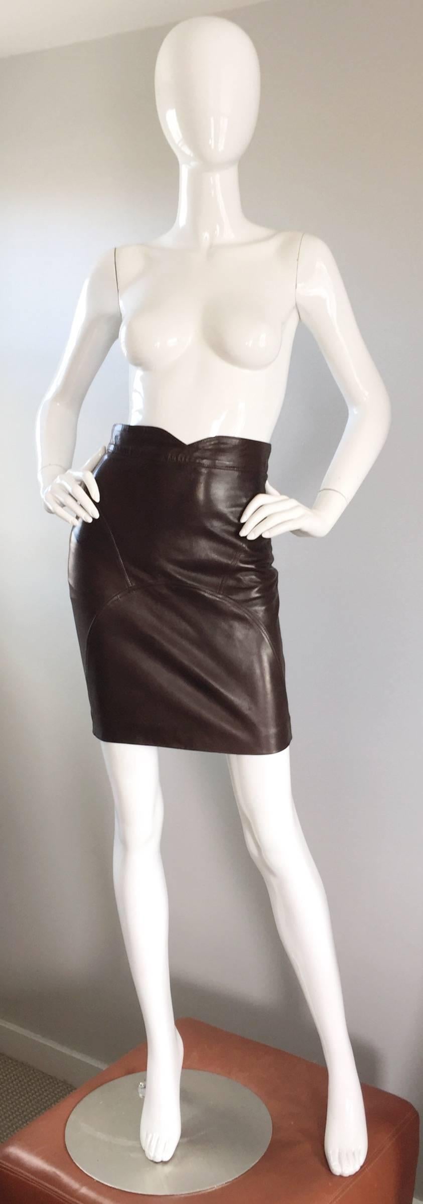 Sexy vintage JEAN CLAUDE JITROIS 1990s chocolate coffee brown leather BodyCon skirt! Features intricate flattering stitching, with a dipped center waistband. Hidden zipper up the back, with button closure. Sucks everything in, and is extremely