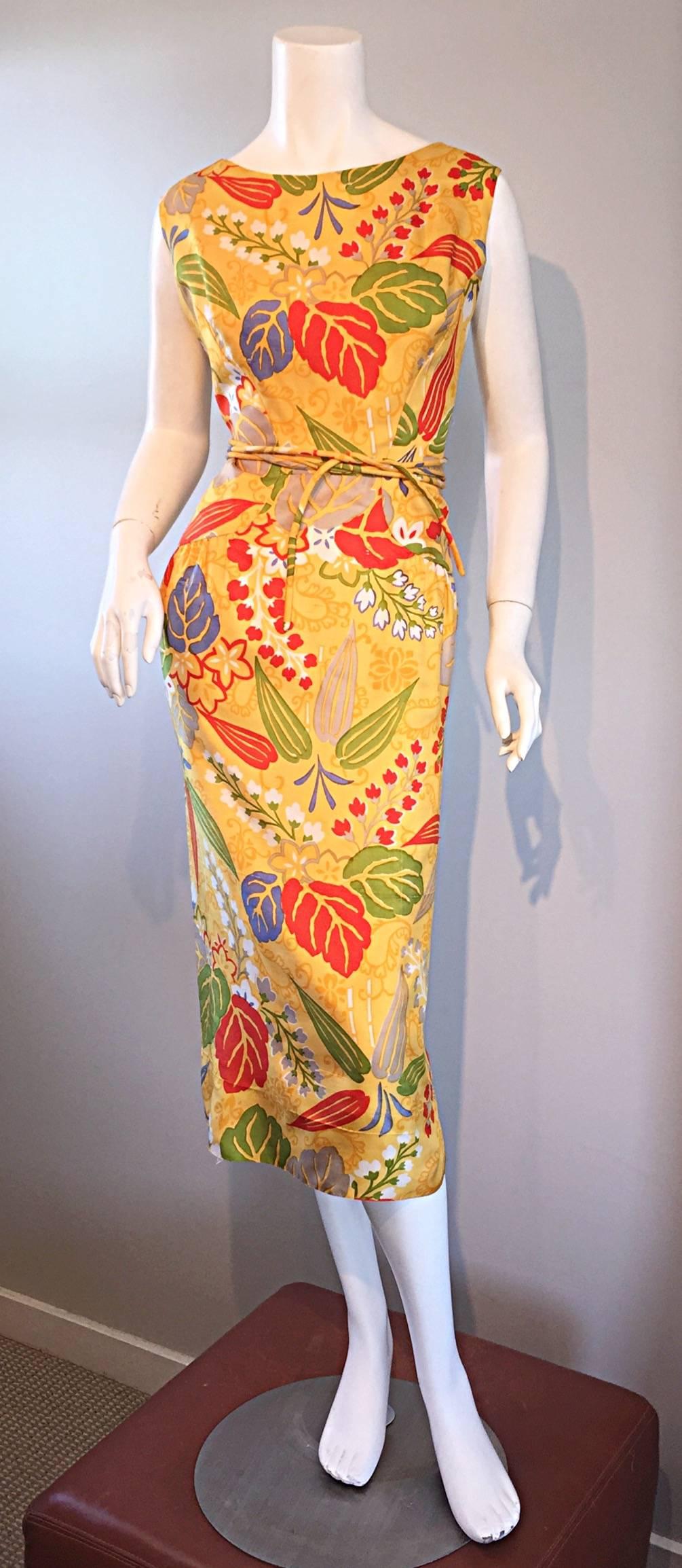 Beautiful vintage 50s ADELE SIMPSON yellow silk dress! Flattering wiggle fit, that flatters a variety of shapes and sizes. Features wonderful all over prints of leaves and flowers. Vibrant hues of green, red, blue and white. Detachable tie belt,