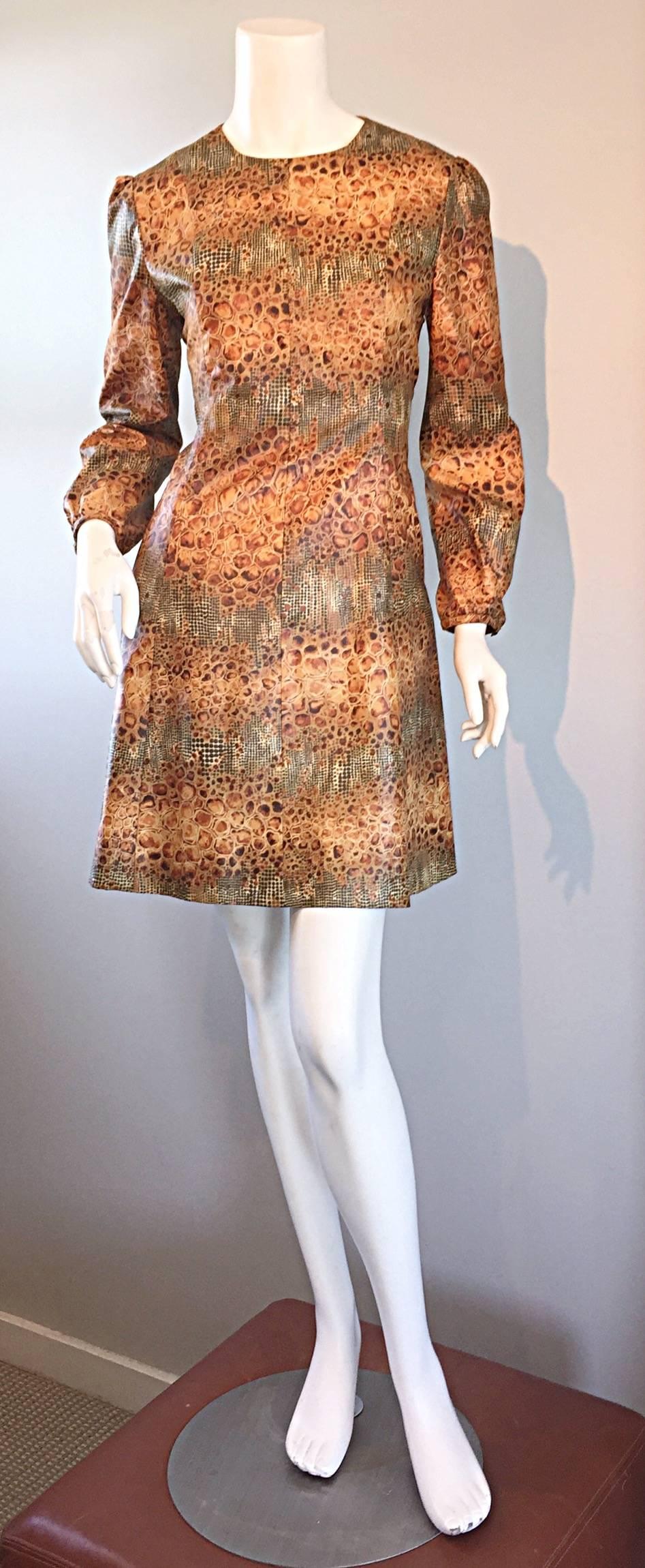 Awesome 1960s reptile print dress! Incredible alligator/crocodile print, mixed with a snake/lizard print. Wonderful flattering A-Line fit. Bubble sleeves, with elastic at each wrist cuff. Full metal zipper up the back. Very well made. Looks great