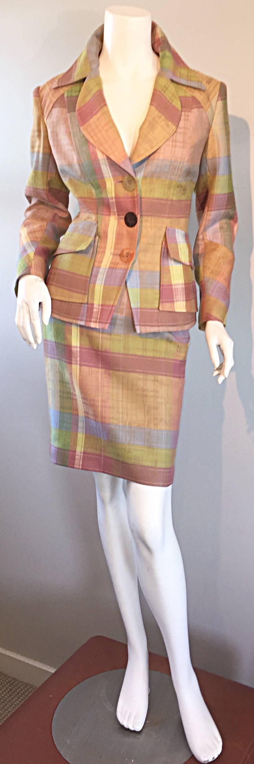 Amazing vintage CHRISTIAN LACROIX 1990s skirt suit! Asymmetrical oversized plaid, with contrasting plaid pockets on jacket. Three unique oversized carved buttons up the bodice. Rounded lapels, with pointed collar. Wonderful pastel colors of light