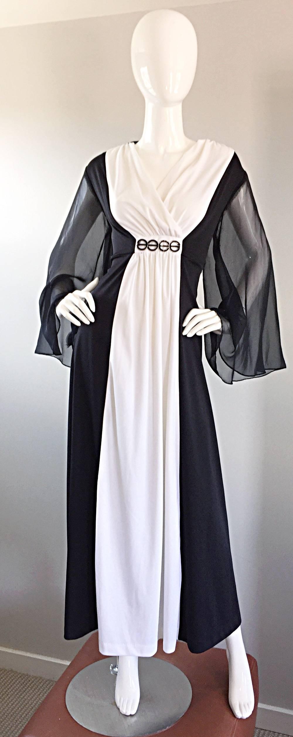 Incredible vintage 1970s black and white color blocked Grecian maxi dress, with black chiffon angel sleeves! Wonderful pleating in all the right places. Attached silver and black metal appliqué at waist. Looks amazing on! Full metal zipper up the