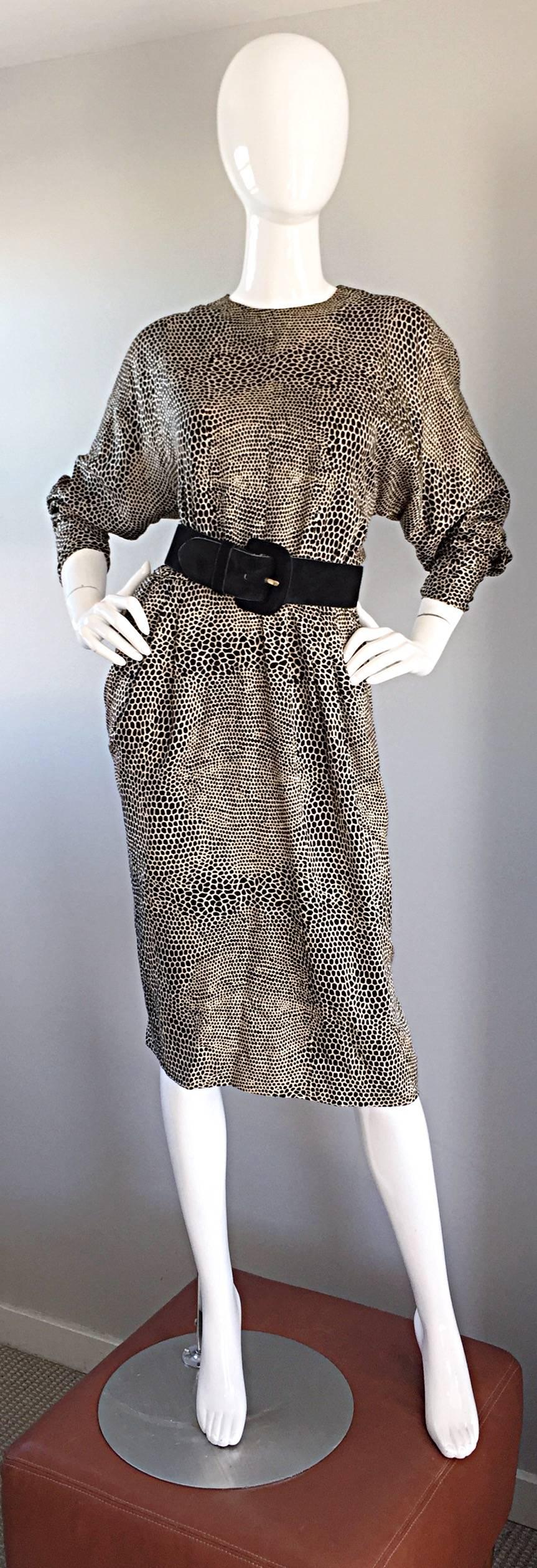 Striking vintage ADELE SIMPSON for NEIMAN MARCUS black and ivory tejus lizard print dress! Features flattering dolman sleeves, which can accommodate an array of bust sizes. Sleek tailored sleeves, with snaps at each cuff to ensure a proper fit at