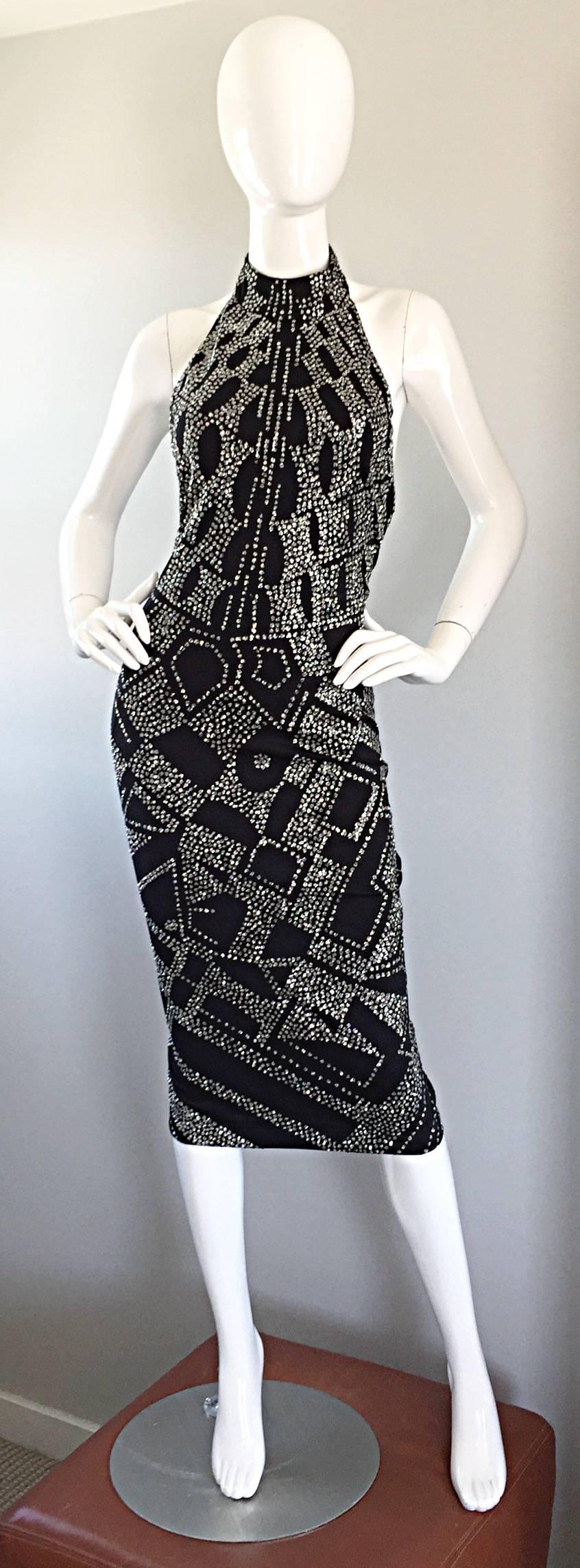 Rare beauty from Bob Mackie's early work! Sexy 70s BodyCon fit, with a stretch to fit double faced jersey material. Features all over silver glitter (not the kind that gets everywhere) with a trompe l' oeil effect. Halter neck, with an open back.