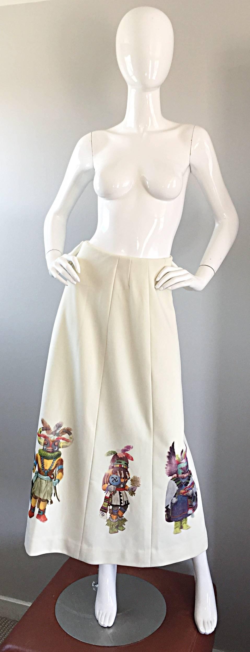 Amazing 1970s Aztec/Mayan Shaman cartoon print novelty maxi skirt! This ivory knit beauty features Shaman Carlton characters screenprinted along the front and back hem. Vertical panels with lots of stretch. Hidden metal zipper up the side with