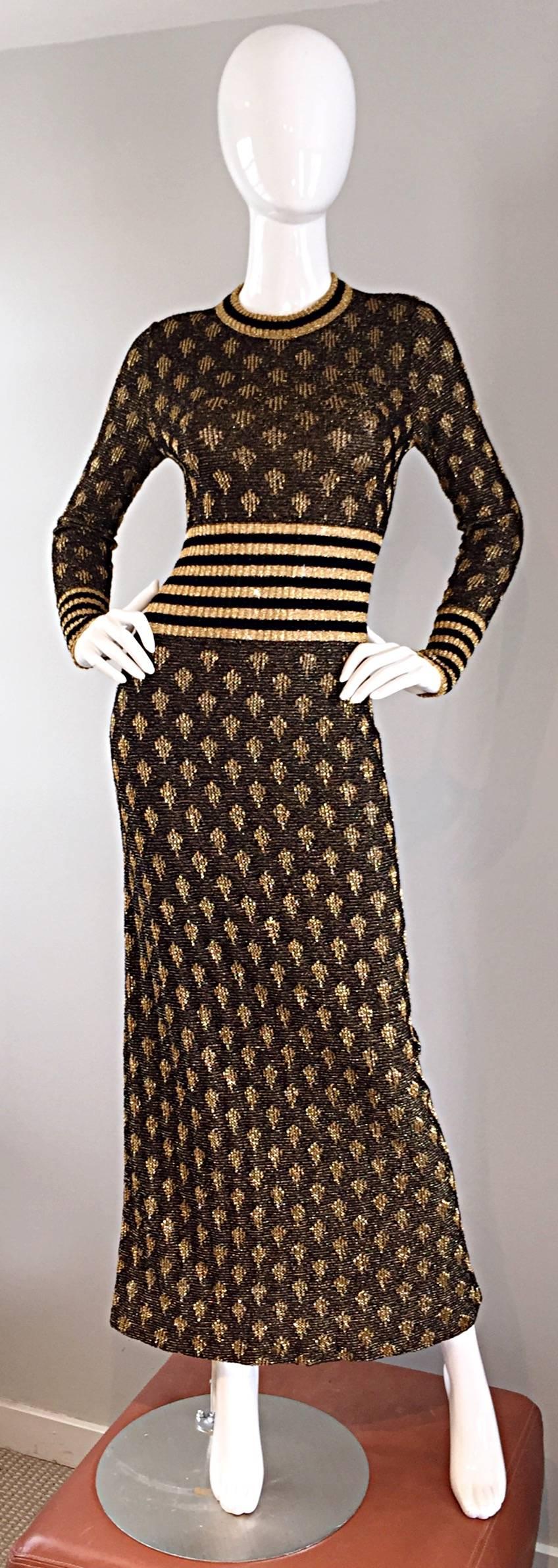 Sensational vintage 70s long sleeve black and gold batik print and striped knit maxi dress! Slimming fit, with flattering stripes at waist and sleeve cuffs. Comfortable knit lurex fabric (feels like cotton). Hidden zipper up the back with