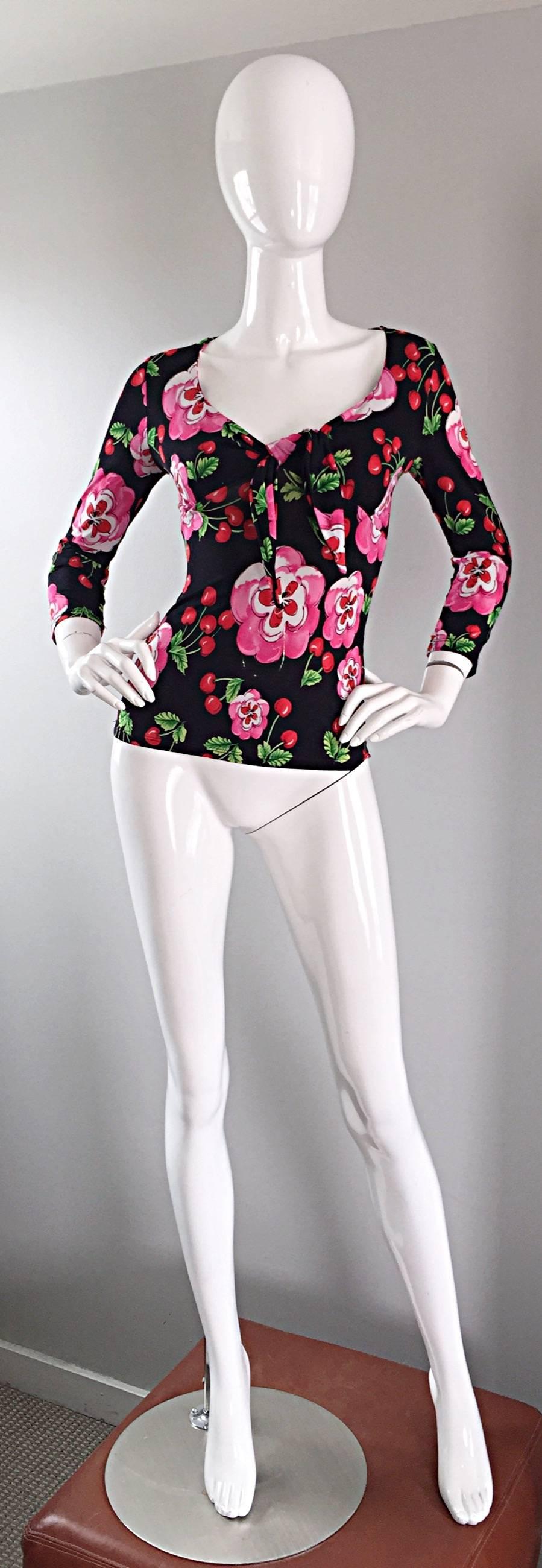 Incredible 90s JUS d'ORANGE (Made in France) cherry print bodycon designer jersey blouse! Features fun prints of red cherries with pink and white flowers throughout. Flattering tie above the bust. Hugs the body in all the right places. Comfortable,