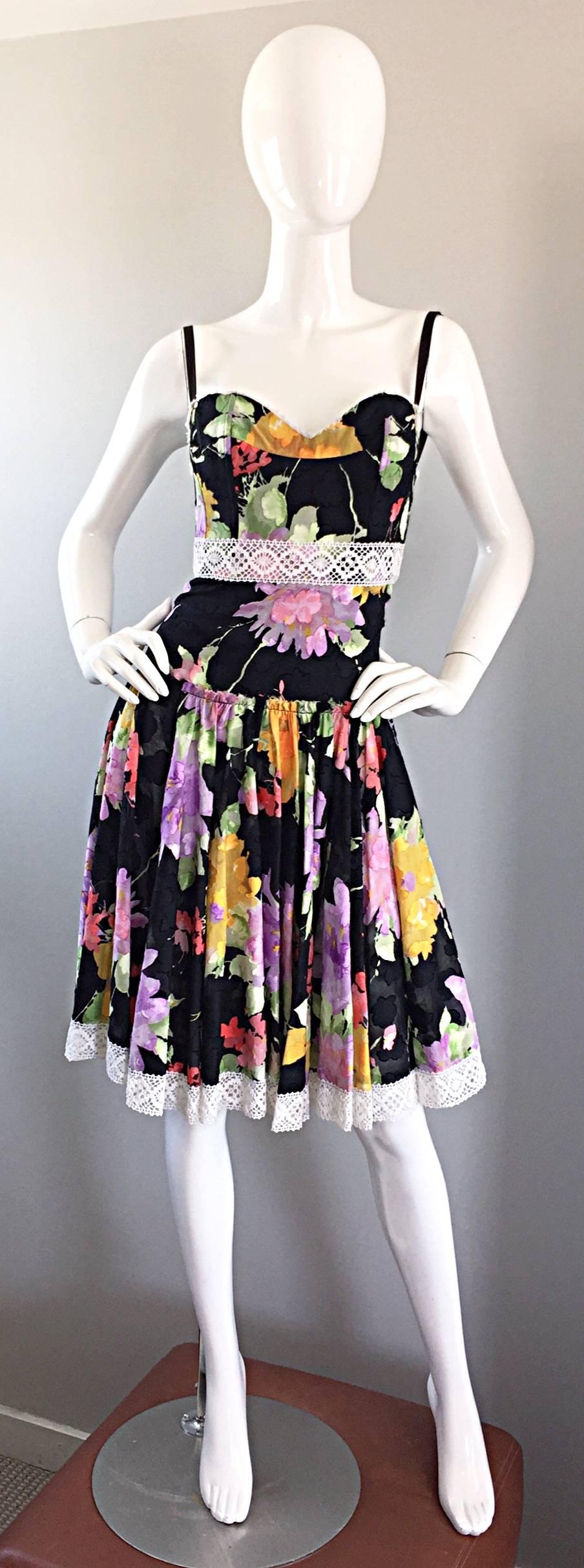 Such a pretty cotton sundress from TRACY FEITH! Black lightweight cotton with multi-colored floral prints throughout. White lace detail at bust, waist, and at the hem. Full skirt, with an ode to the 1950s / 50s. Extremely well made, with a
