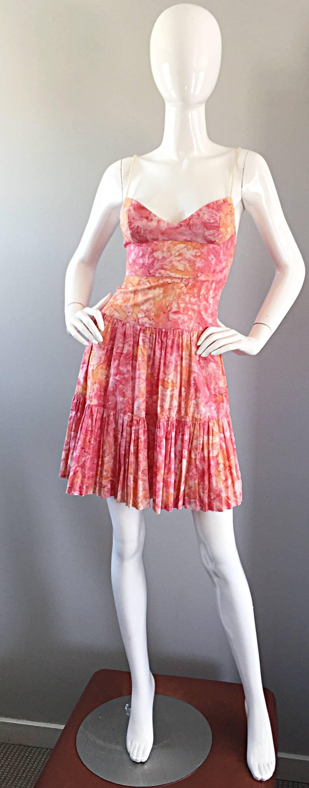 Adorable TRACY FEITH pink, orange and white swirled watercolor print cotton tiered dress! Features tan rope spaghetti straps. Fitted bodice with a tiered ruffle hem. Incredible ode to the 50s with a whimsical flare.Hidden zipper up the back with