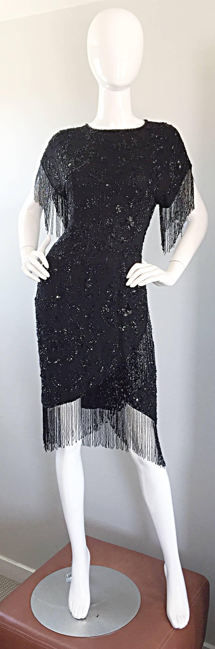 Exceptional vintage OLEG CASSINI black silk beaded 'Flapper' style dress! Features all-over (THOUSANDS) hand-sewn sequins and beads, with intricate beaded fringe hanging from the arms, and throughout the front and back hem. Peek-a-boo back that